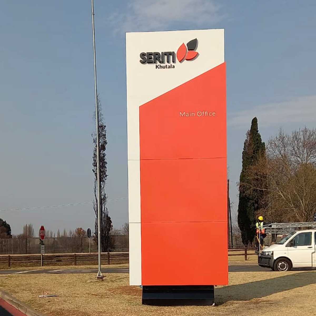 Corporate entrance pylon sign with dimensional business logo